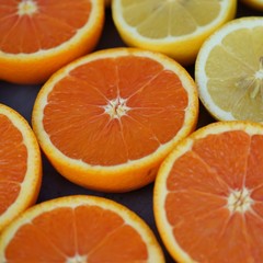 Juicy orange and lemon citrus cut in half