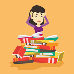 Student sitting in huge pile of books.