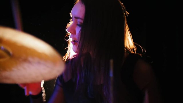 Girl percussion drummer performing with drums, slow motion
