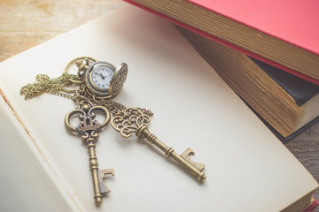 Old vintage key on  stack of old book with copy space in morning light for unlock or eductaion concept