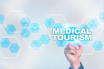 Medical doctor drawing medical tourism on the virtual screen.