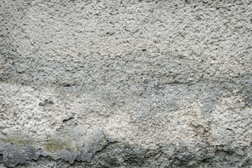 grunge textured backgroundold. concrete wall of the house with the remnants of plaster