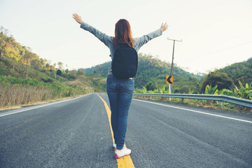 young women happy walking on the road at mounthain and sunet