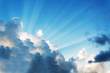 beautiful cloud on blue sky with light rays. subject is blurred and low key