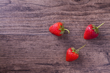 Strawberries on wood texture background