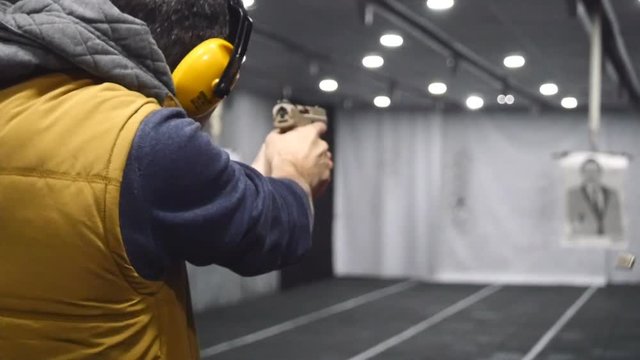 Man shooting with a pistol in slow motion