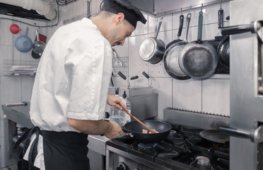 chef cooking pan meat