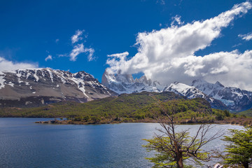 Obraz premium Landscape with the lake Capri in Patagonia with the view on Fitz Roy mountain covered with snow and clouds.
