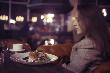 portrait of a pensive girl in a restaurant at the table