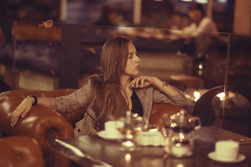 Fototapeta premium beautiful young adult girl having dinner in a restaurant