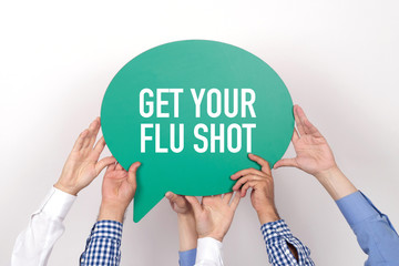 Group of people holding the GET YOUR FLU SHOT written speech bubble - 138795981