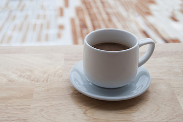 Coffee cup and bread on wooden table, selective focus and soft focus