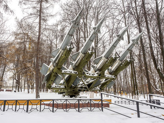 Anti-aircraft missiles bombarded day with snow in the park in winter.