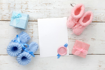 Set of baby girl and boy booties and greeting card form. Top view