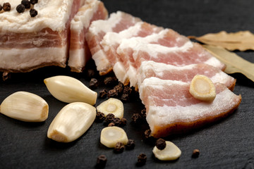 Fresh bacon with garlic and peppercorns, bay leaf. Ukrainian traditional cuisine.