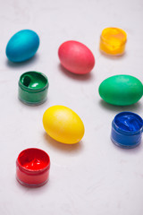 Happy Easter! Friends painting Easter eggs on table.