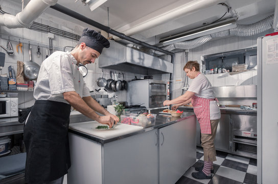 two people cooking, commercial kitchen