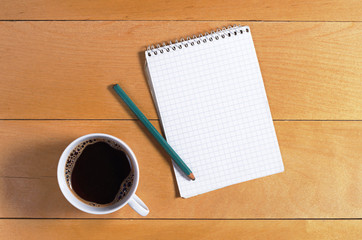 Notebook and coffee cup