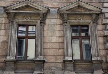 Glass window in the facade of an old house