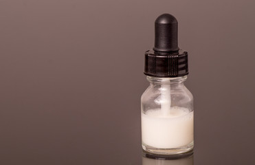 dropper bottle with milk white liquid