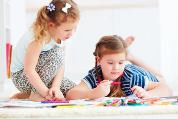 Fototapeta premium happy young girls, kids painting with felt pen together