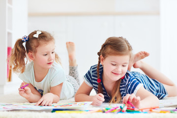 Fototapeta premium happy young girls, kids painting with felt pen together