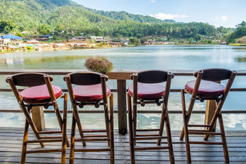 Viewpoint ancient tribe village with chair on lake at ban rak thai