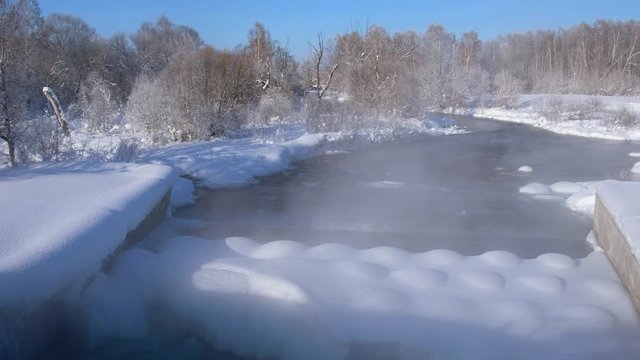 Dam between pond of Kokshi and river Koksha in Altai region in winter season