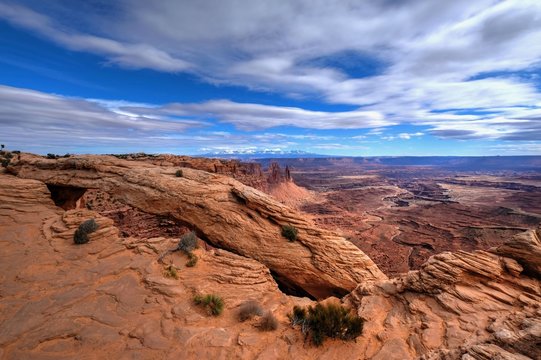 Sandstone arch and canyon under blue sky. Mesa Arch. Canyonlands National Park. Moab. Cedar City. Utah. United States.