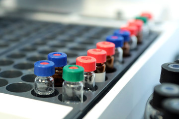 Obraz premium Bottles check on the quality of the suspension. Quality Control Laboratory medicine. Chromatograph operation.