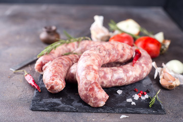 Raw sausages on slate