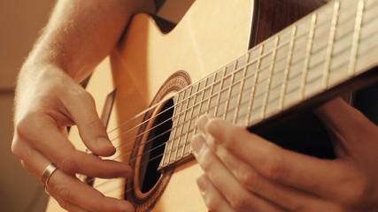 Fototapeta premium Hands of guitarist playing a guitar
