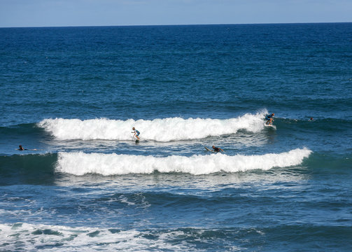  Surfers in action on Madeira Island. Portugal