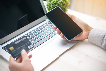 Online payment,hand using phone on worktable