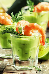 Shrimp and avocado, old wooden background, selective focus