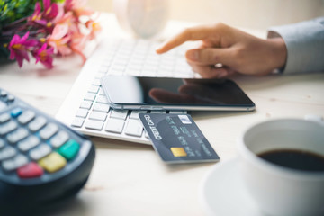 Online payment,hand using phone on worktable