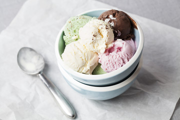Mixed flavor ice cream scoops in bowl