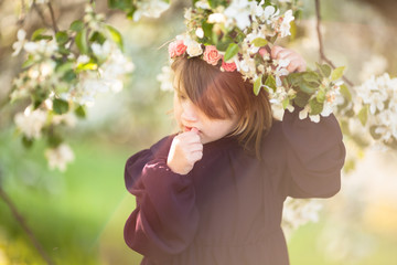 Girl child in  wreath of flowers, spring flowers