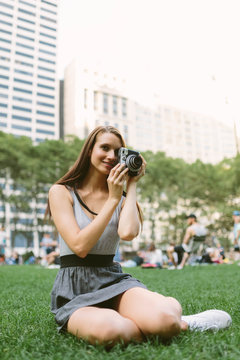 Young American Girl Using a Vintage Camera in Briant Park . Manhattan New York City US