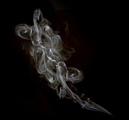 a cloud of cigarette smoke on a black background