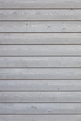 vertical part of horizontal planks with light grey paint