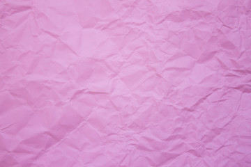 Crumpled recycle pink paper background.
