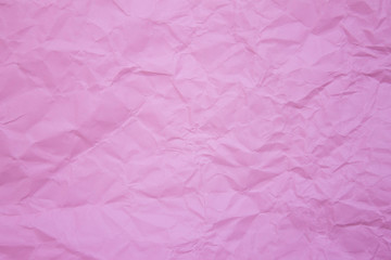 Crumpled recycle pink paper background.