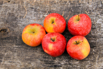 Red apples on wooden background