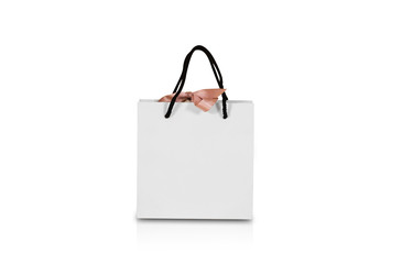 Blank white paper gift bag with a bow mock up. Isolated on white background. Empty plastic package...