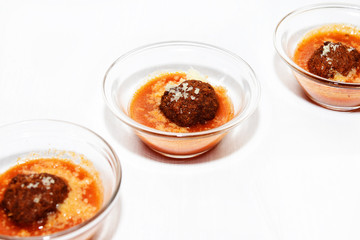meatballs with tomato sauce, single portion in small glass bowls