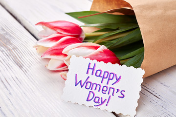 Bouquet of tulips and card. Celebration of Women's day.