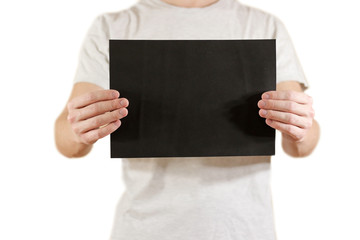 Man holding black A4 paper horizontally. Leaflet presentation. Pamphlet hold hands. Man show clear offset paper. Sheet template. Booklet design sheet display read first person