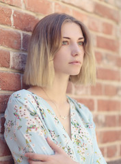 Outdoors portrait of beautiful young woman with green eyes.