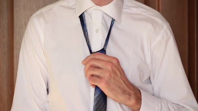 Businessman taking off a tie